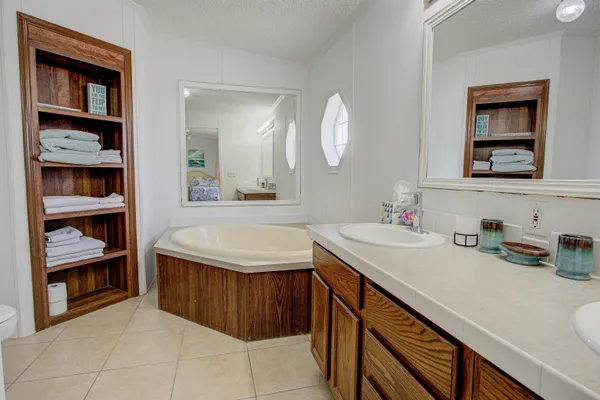 a bathroom with a granite countertop sink a toilet and a mirror
