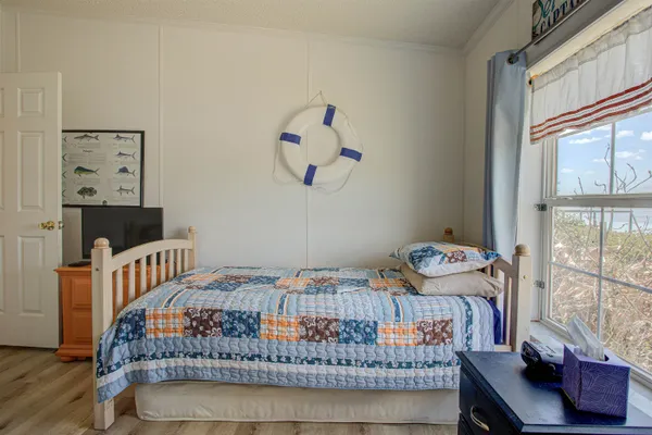 a bedroom with furniture and a window