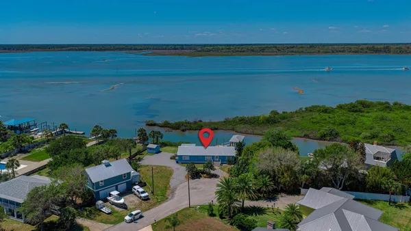 an aerial view of a house with a lake view