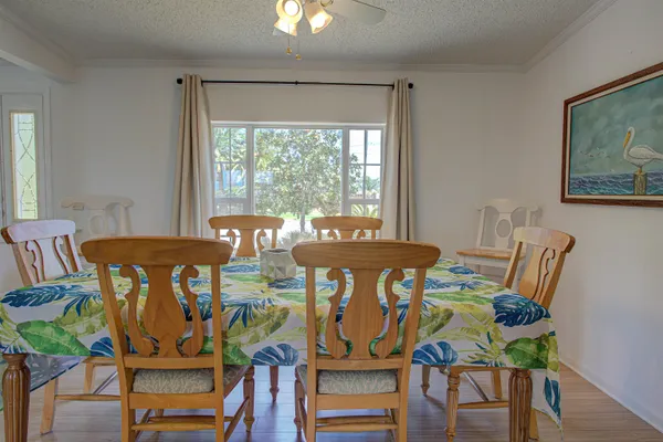 a view of a dining room with furniture window and wooden floor