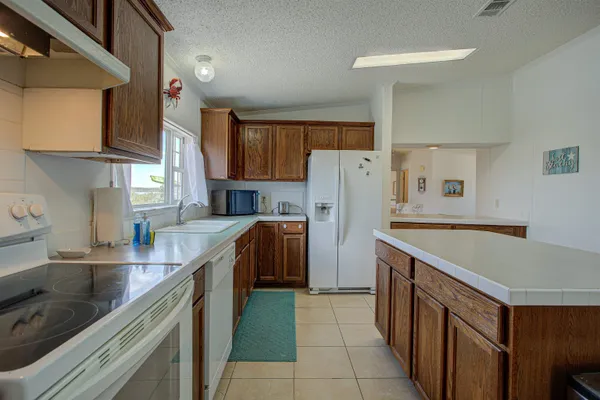 a kitchen with a refrigerator a sink and a stove