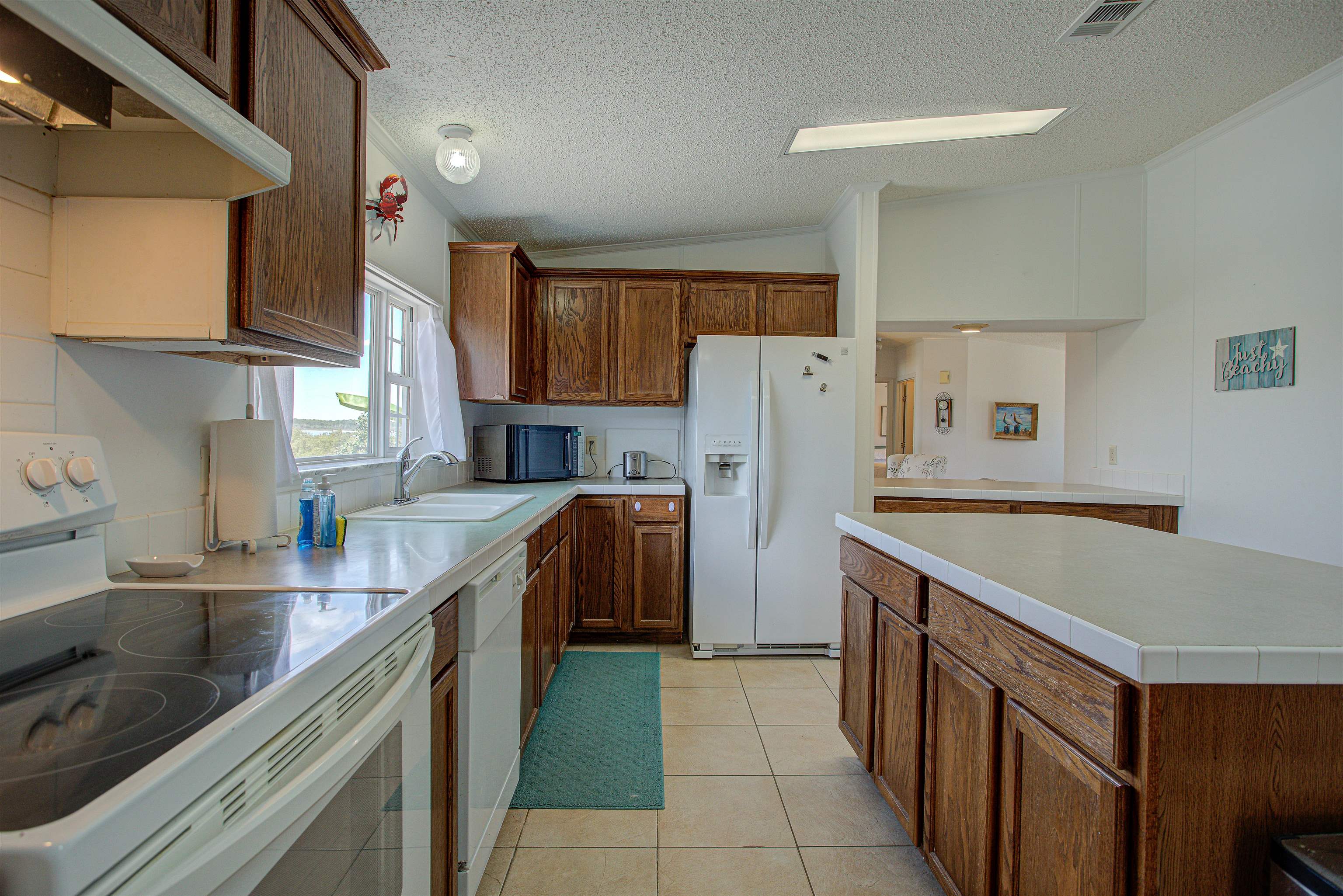 6347 Salado Road St. Augustine, FL 32080 - Photo 28 of 40 a kitchen with a refrigerator a sink and a stove