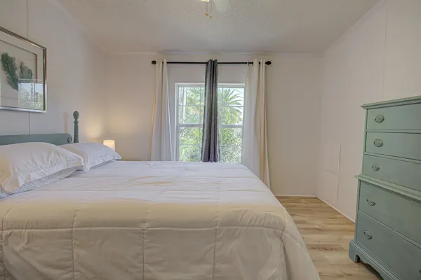 a bedroom with a bed and a window