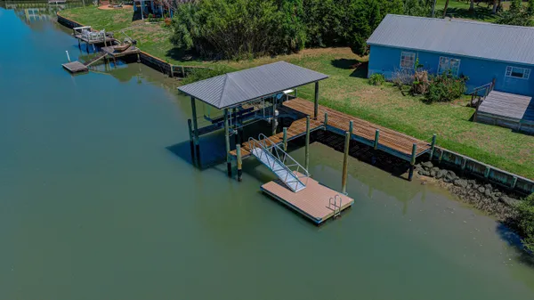 an aerial view of a house with a yard