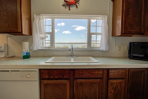 a kitchen with a sink cabinets and a window
