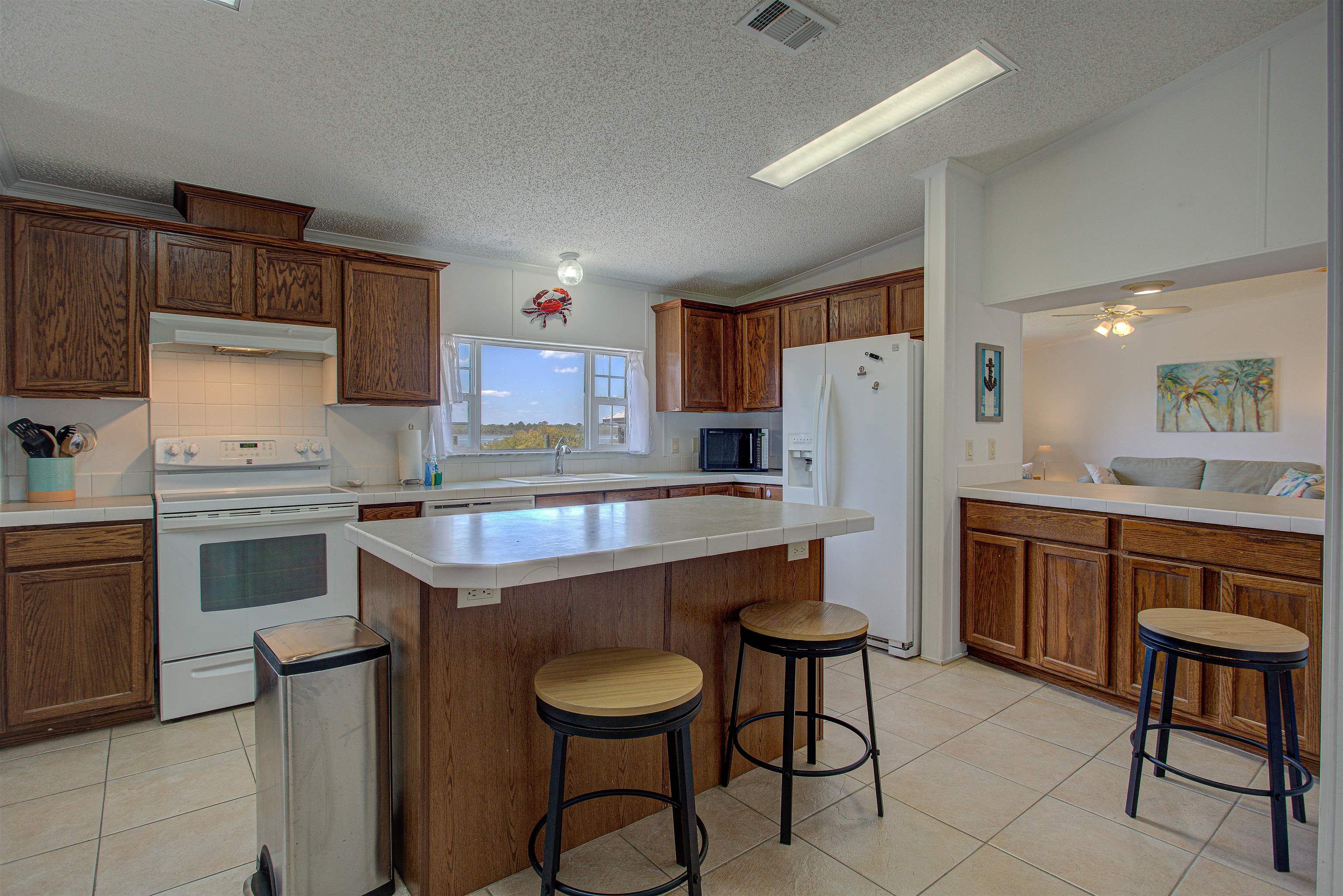 6347 Salado Road St. Augustine, FL 32080 - Photo 8 of 40 a kitchen with a sink a stove a refrigerator and chairs