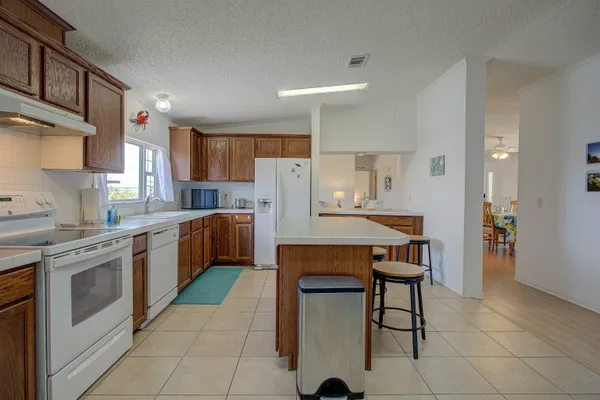 a kitchen with a table chairs sink and cabinets