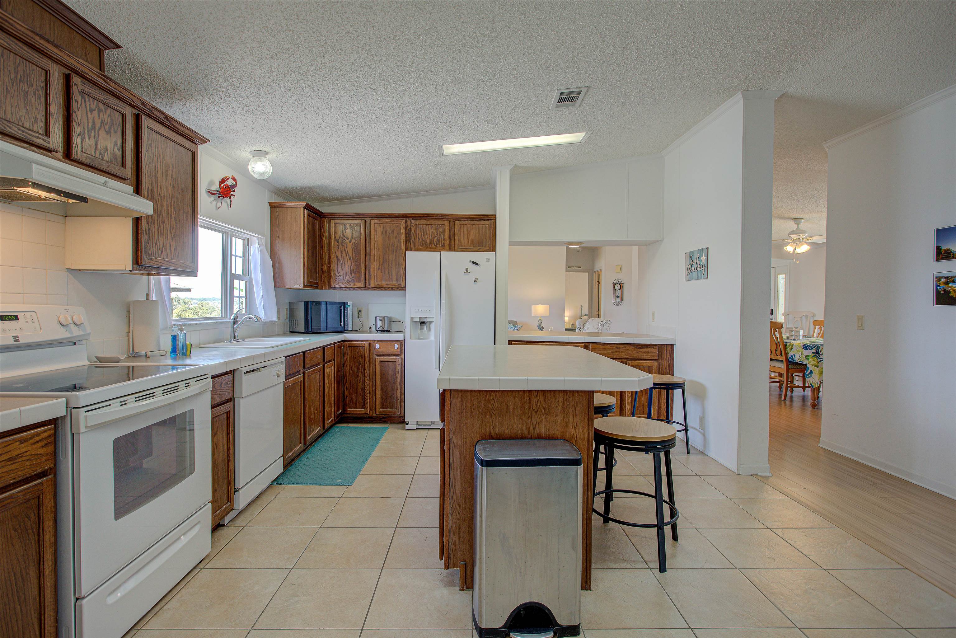 6347 Salado Road St. Augustine, FL 32080 - Photo 9 of 40 a kitchen with a table chairs sink and cabinets