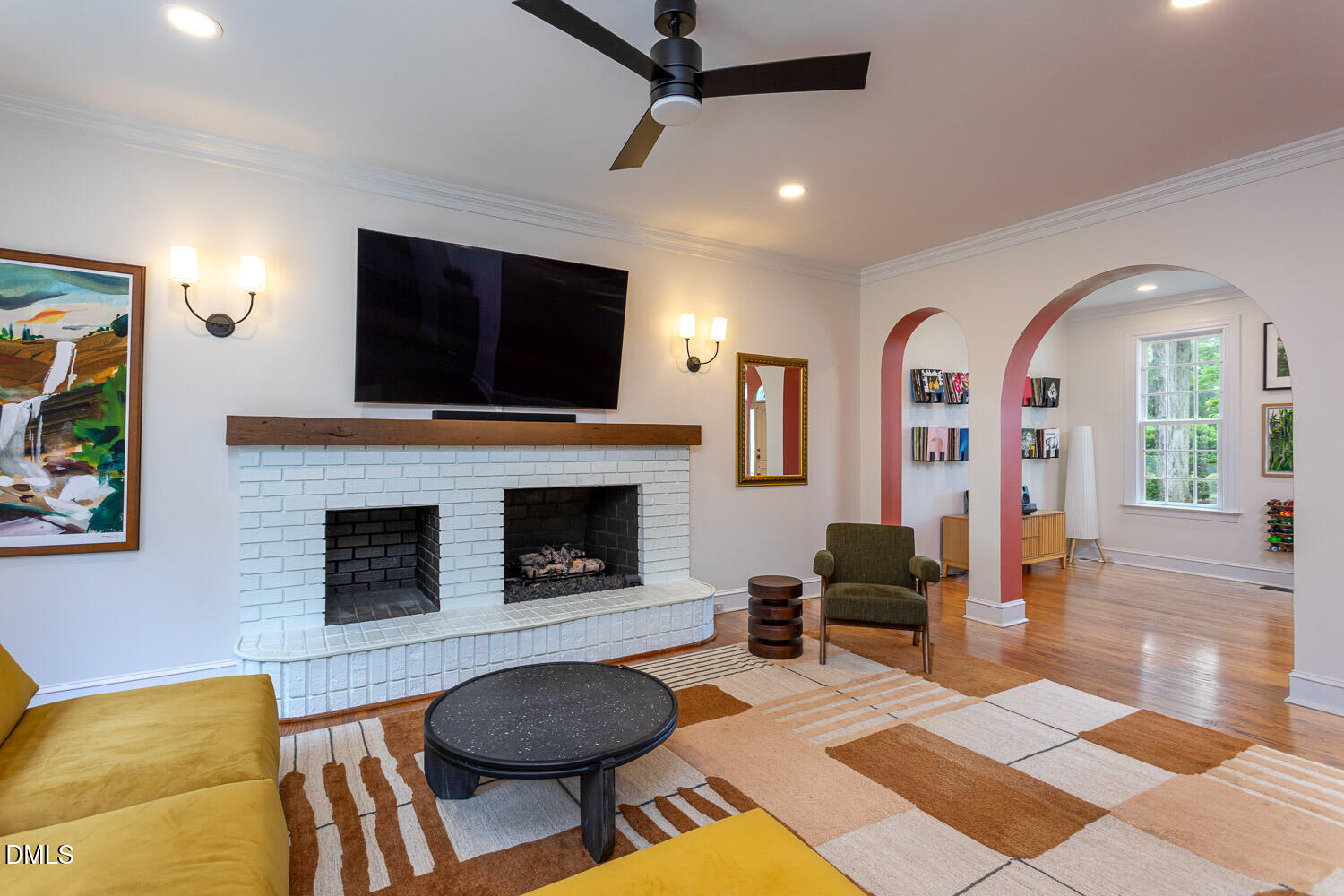 8509 Towneley Place Raleigh, NC 27615 - Photo 7 of 36 a living room with furniture a flat screen tv and a fireplace