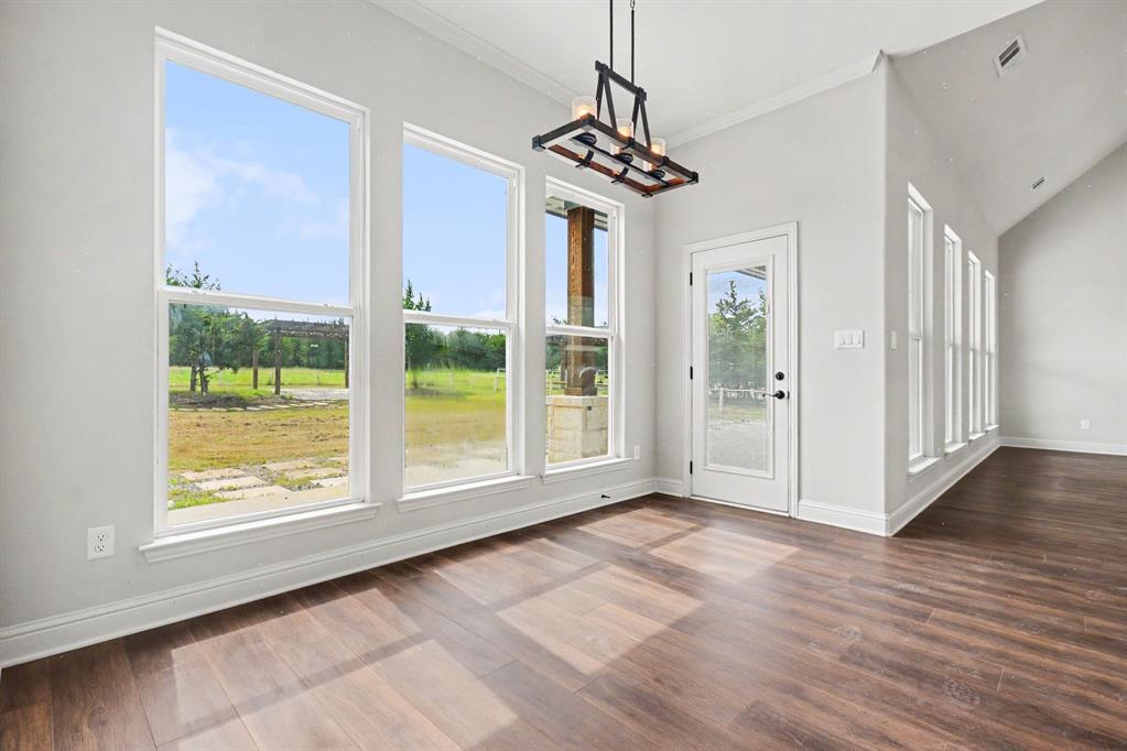 530 P R 491 Leonard, TX 75452 - Photo 8 of 35 Spacious room featuring wood-finish flooring and a series of floor-to-ceiling windows