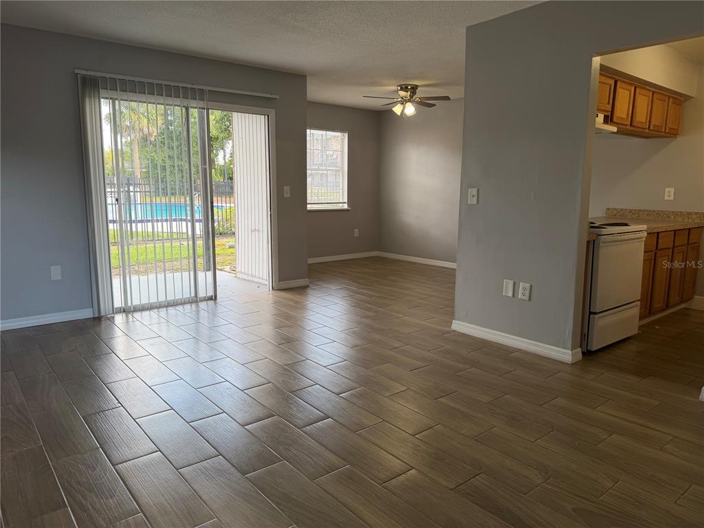5317 Curry Ford Road, Unit P104 Orlando, FL 32812 - Photo 5 of 9 an empty room with wooden floor and windows
