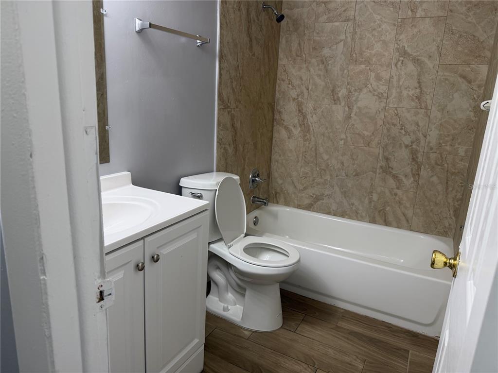 5317 Curry Ford Road, Unit P104 Orlando, FL 32812 - Photo 7 of 9 a bathroom with a sink a toilet and bathtub