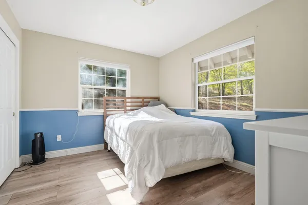 a bathroom with a granite countertop sink a toilet and a mirror