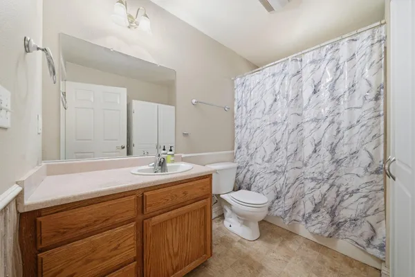 a bedroom with furniture and a large mirror