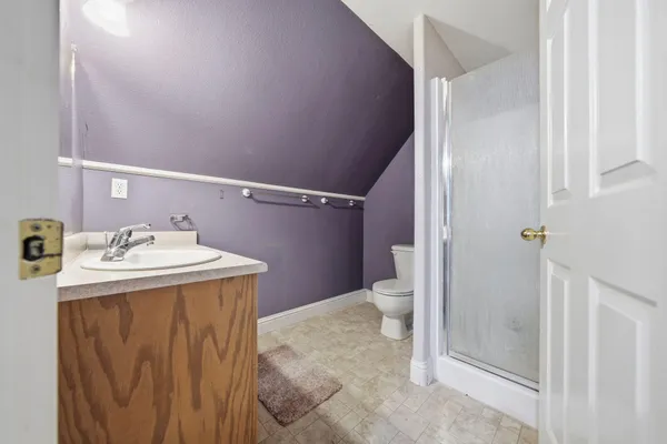 a kitchen with granite countertop white cabinets and a stove