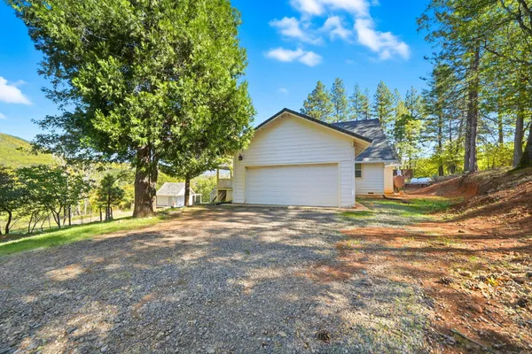 a view of a yard with a house and trees