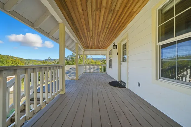 a view of a balcony with wooden floor