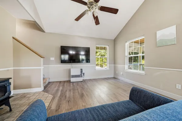 a living room with furniture and wooden floor