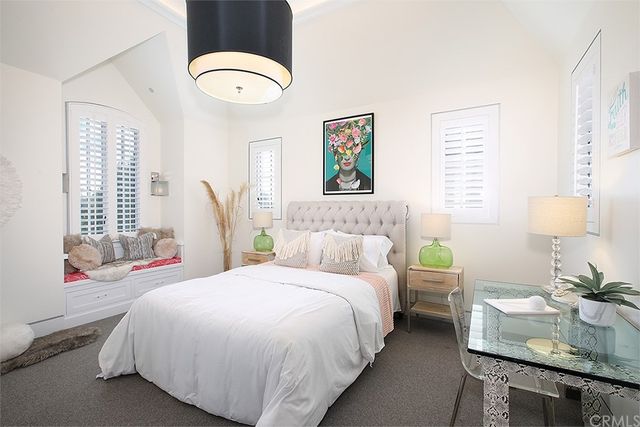 a bedroom with bed and a chandelier