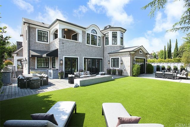 a view of a patio with couches table and chairs and potted plants