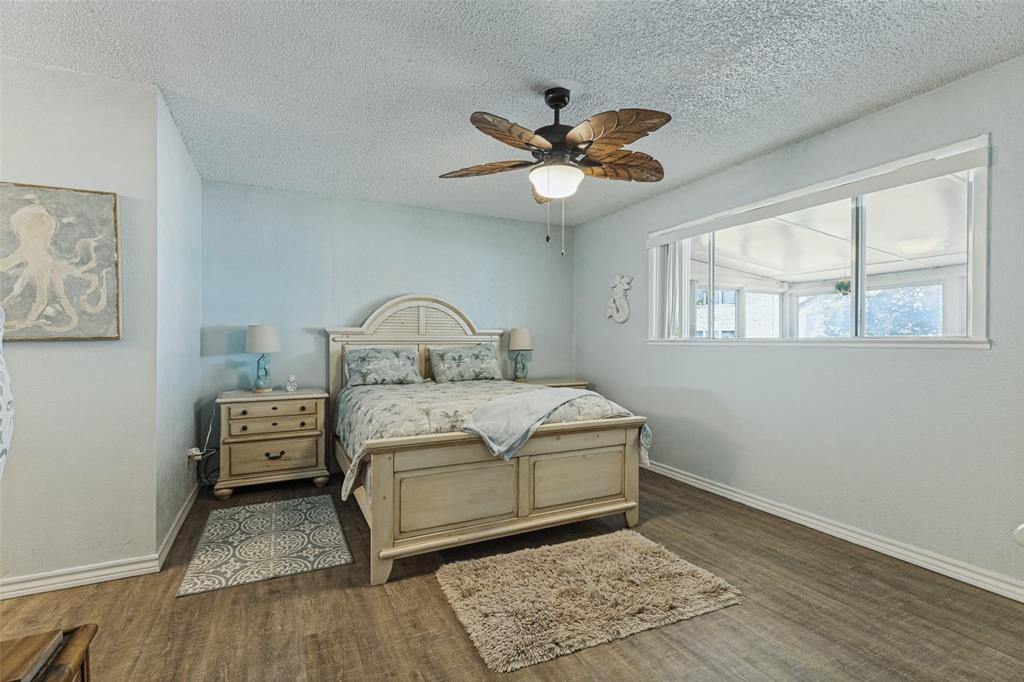 12960 Gantt Road East Azle, TX 76020 - Photo 10 of 26 Wood-finish flooring, overhead ceiling fan with lighting, and a white-framed window