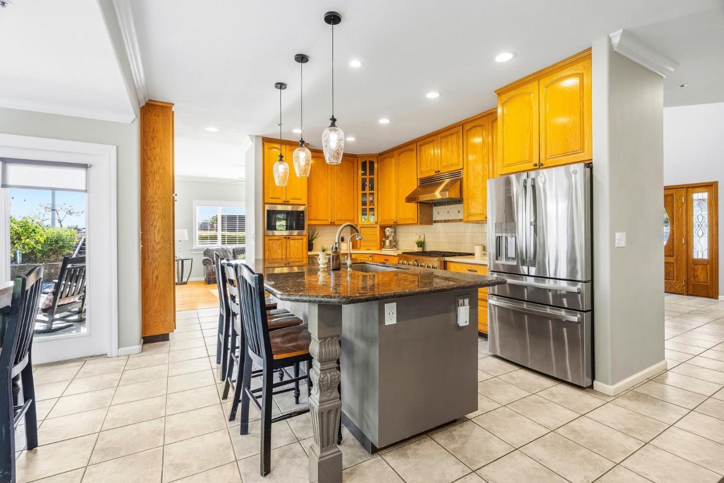 2500 Nelson Road Scotts Valley, CA 95066 - Photo 4 of 77 a kitchen with stainless steel appliances granite countertop a table chairs and a refrigerator