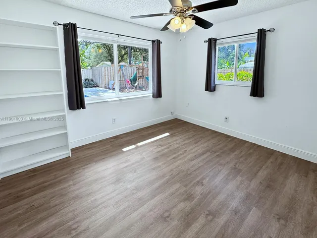 a view of an entryway with wooden floor