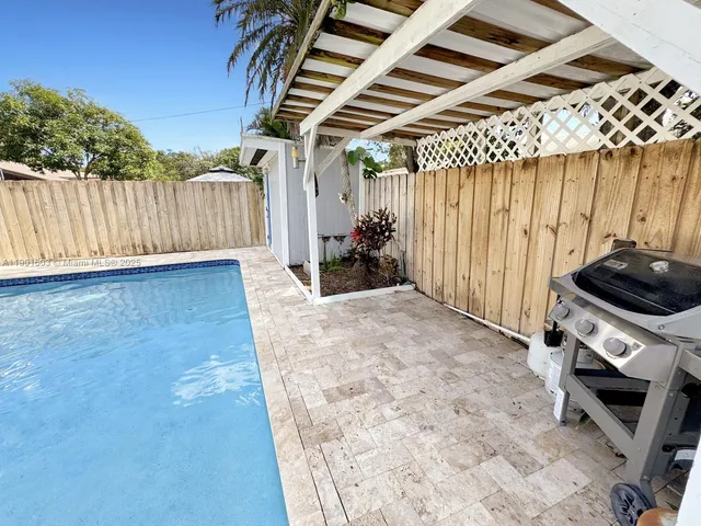 a view of a backyard with furniture and a tub
