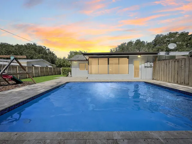 a view of a house with a backyard