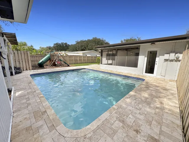 a view of a house with a backyard