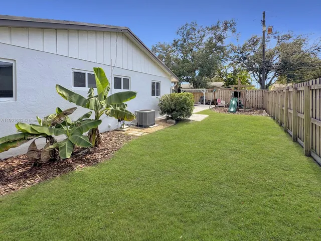 a view of a backyard with plants and a patio