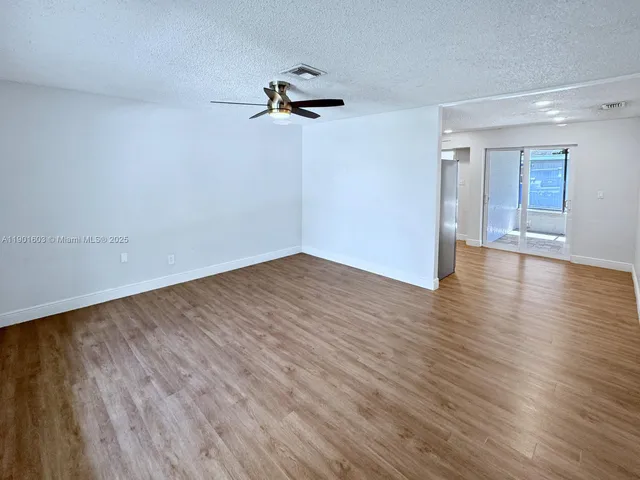 a view of a room with wooden floor