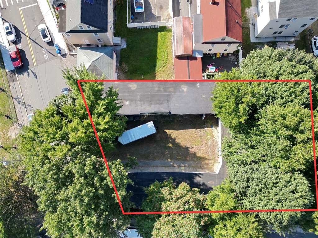 an aerial view of a house with a yard and garden