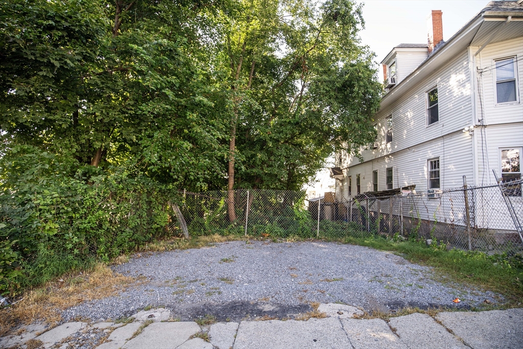 0 Hudson Lawrence, MA 01841 - Photo 20 of 20 a view of a backyard with large trees and wooden fence