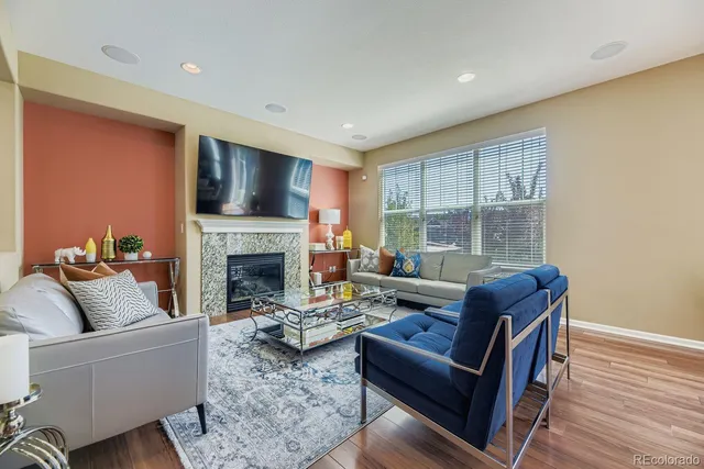 a living room with furniture and a fireplace