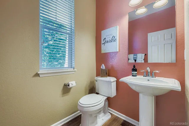a bathroom with a sink toilet and a mirror