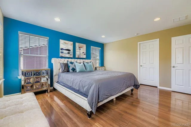 a bedroom with a large bed and a window