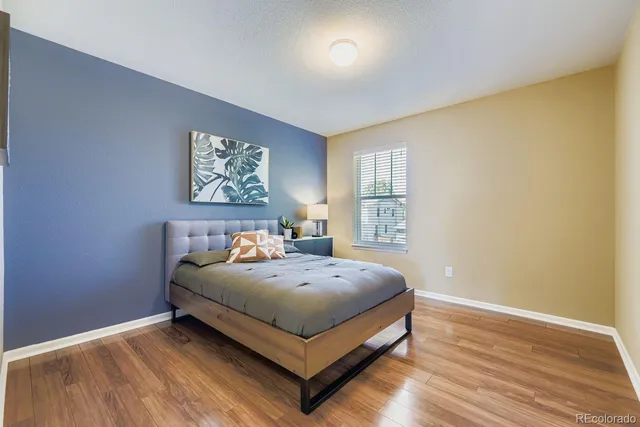 a bed sitting in a bedroom next to a window