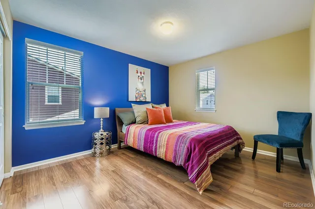 a bed sitting in a bedroom next to a window