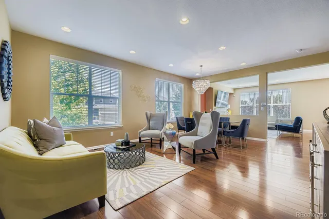 a living room with furniture and large windows