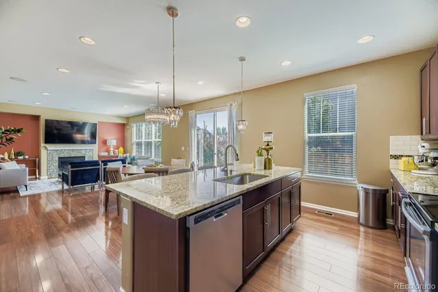 a kitchen with sink stove and refrigerator