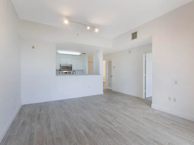 a view of a kitchen with wooden floor and a sink