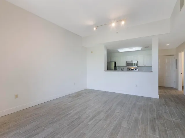 a view of a kitchen with a dishwasher and wooden floor