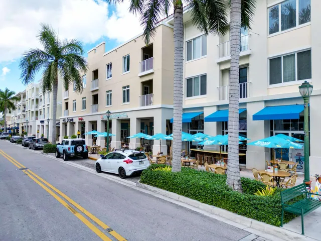 a front view of multiple houses with yard