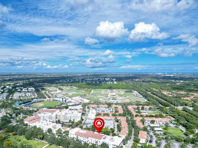 a front view of a house with a yard and green space