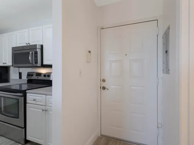 a kitchen with a refrigerator and cabinets