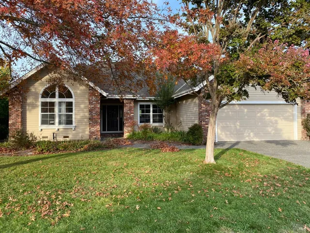 a front view of house with yard and green space