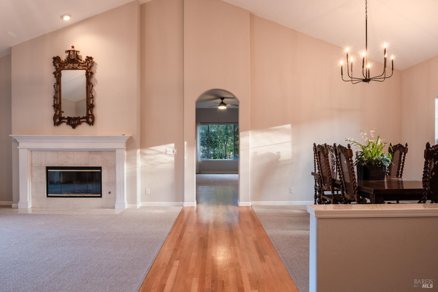 6261 Meadowstone Drive Santa Rosa, CA 95409 - Photo 19 of 21 a view of a livingroom with a fireplace wooden floor and a chandelier