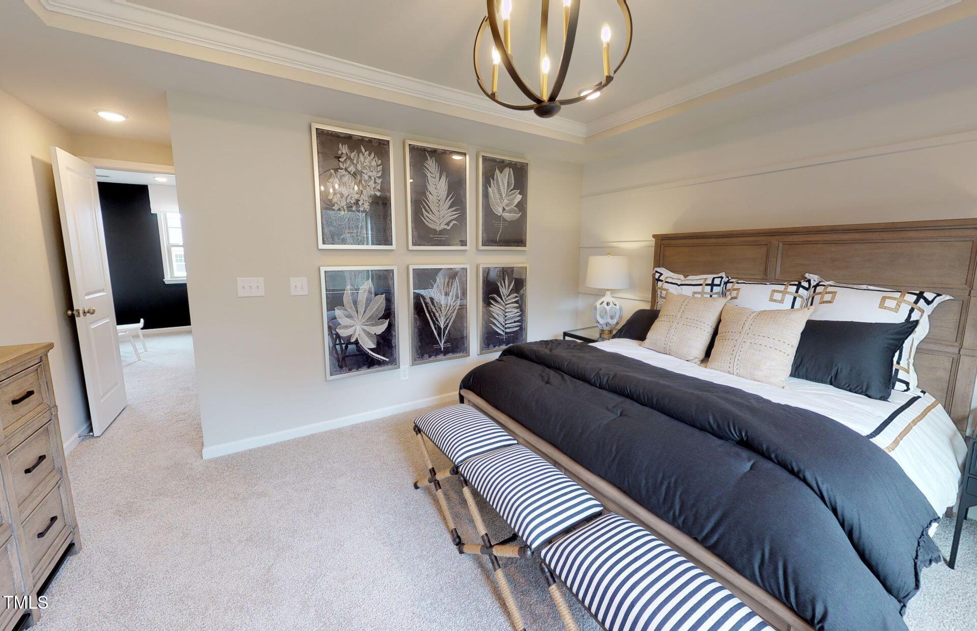 1105 Freestone Road Durham, NC 27703 - Photo 11 of 21 a bedroom with a large bed and a chandelier