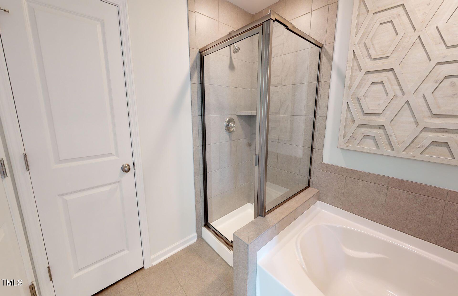 1105 Freestone Road Durham, NC 27703 - Photo 14 of 21 a bathroom with a tub and shower